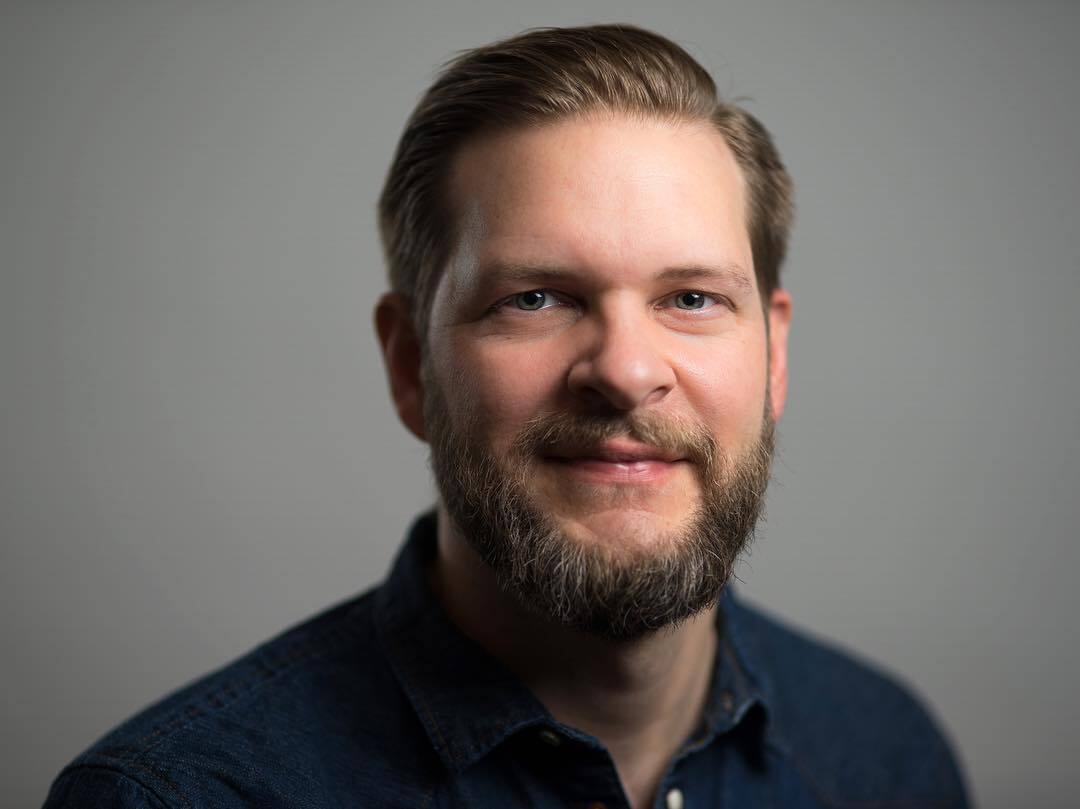 Jon Clark — studio headshot, gray background
